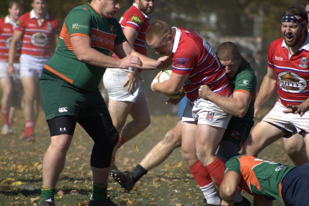 Players from Charles River Rugby tackling a Portland Rugby Player